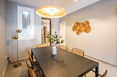 a dining room with a black table and chairs at 21MAL1089-Magnific apartment near Sagrada familia in Barcelona