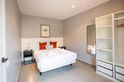 a bedroom with a large white bed and shelves at 21MAL1089-Magnific apartment near Sagrada familia in Barcelona