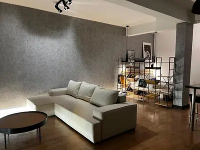 a living room with a white couch and a table at Loft en Gracia in Barcelona