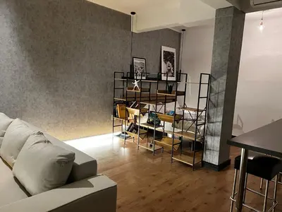 a living room with a white couch and chairs at Loft en Gracia in Barcelona