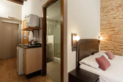 a small room with a bed and a bathroom at AinB Picasso-Corders Apartments in Barcelona