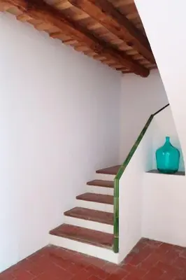 a stairway with a blue vase on a wall at Charming house in Sant Pol facing the sea in San Pol de Mar