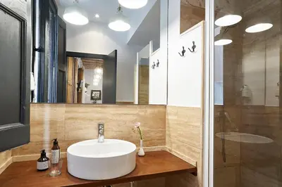 a bathroom with a sink and a mirror at AinB Gothic-Jaume I Apartments in Barcelona