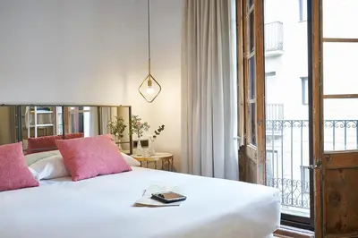 a bedroom with a bed with a book on it at AinB Gothic-Jaume I Apartments in Barcelona