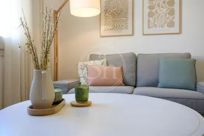 a living room with a table and a couch at Luminescent Valencia Apartment in Barcelona
