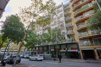 a patio with a bed and chairs and a table at Bonito apartamento con terraza in Barcelona
