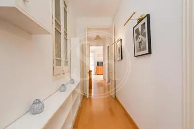 a living room with a table with a bowl of bread on it at Bonito apartamento en el Eixample in Barcelona