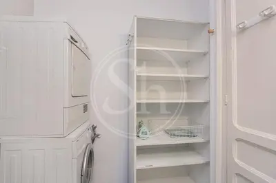 a white refrigerator freezer sitting next to a white refrigerator freezer at Bonito apartamento en el Eixample in Barcelona