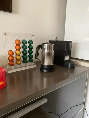 a counter with a coffee maker and donuts on it at Piso cómodo Habitación in Sabadell