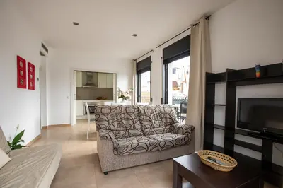 a living room with a table and white chairs at Purple Dream in Sitges