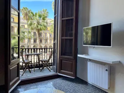 an open door to a balcony with a view of a building at Barcelona Classic Plaza Real Apartments in Barcelona