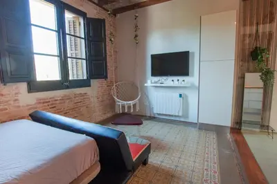 a bedroom with a bed and a tv in a room at Barcelona Classic Plaza Real Apartments in Barcelona