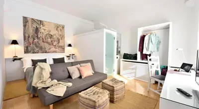 a living room with a gray couch in a room at Hotel Can Carol in Capellades