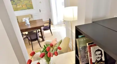 a living room with a vase of flowers on a table at Hotel Can Carol in Capellades