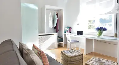 a living room with a couch and a desk at Hotel Can Carol in Capellades