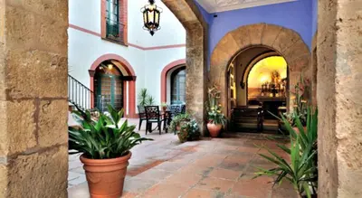 a courtyard with potted plants in a building at Hotel Can Carol in Capellades