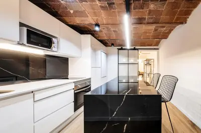 a living room with a couch and a tv at BeBarceloner Sants Apartments- 3 bedroom in Barcelona