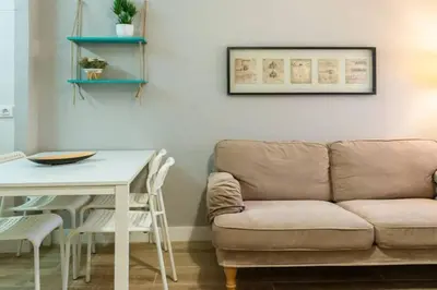 a living room with a couch and a table at BeBarceloner Vall Hebron Apartment in Barcelona