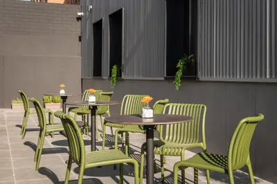 a row of tables and chairs at a restaurant at Aerohotel Barcelona Airport 24h in El Prat de Llobregat