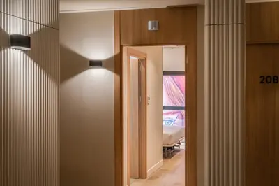 a hallway with a door and a mirror in a room at Aerohotel Barcelona Airport 24h in El Prat de Llobregat