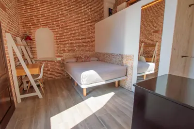 a living room with a couch and a brick wall at Barcelona Classic Catedral Apartments in Barcelona
