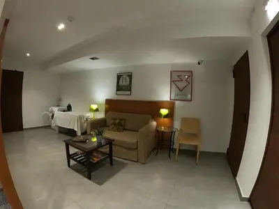 a living room with a couch and a table at Sitges rooms by Sitges Apartment in Sitges