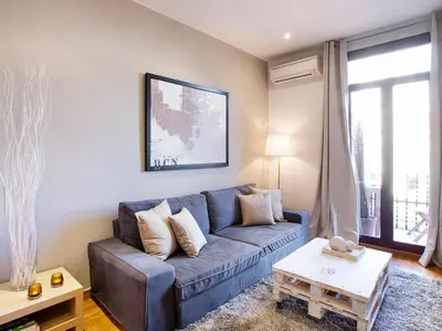 a living room with a blue couch and a table at Apartment in Barcelona near Seabeach in Barcelona