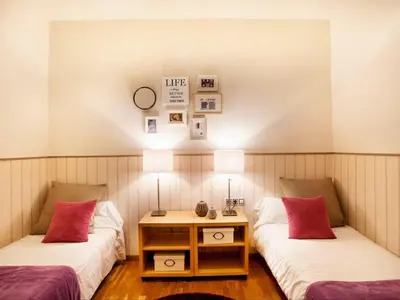 a room with two beds and a table with two lamps at Apartment in Barcelona near Seabeach in Barcelona