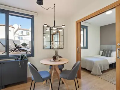 a room with a table and chairs and a bed at Penthouse in Barcelona with Large Terrace in Barcelona