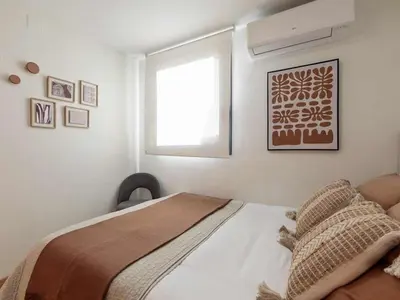 a bedroom with a bed with pillows and a lamp at Penthouse in Barcelona with Large Terrace in Barcelona
