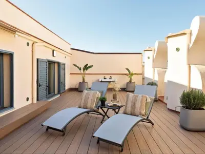 a table and chairs on a patio with a kitchen at Penthouse in Barcelona with Large Terrace in Barcelona