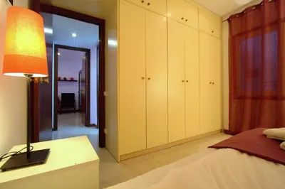 a bedroom with a bed and a lamp on a table at La Pedrera Residence in Barcelona