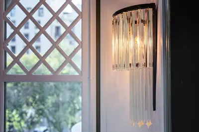 a chandelier hanging in front of a window at The Diagonal Suites by Sweett in Barcelona