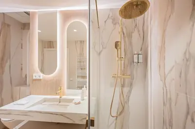 a bathroom with a sink and a shower at The Diagonal Suites by Sweett in Barcelona