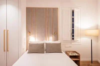 a bedroom with a white bed and a window at The Diagonal Suites by Sweett in Barcelona