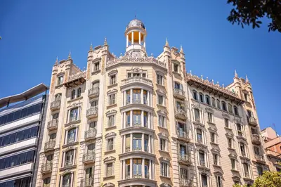 a large building with a tower on top of it at The Diagonal Suites by Sweett in Barcelona