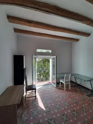 a living room with a table and chairs and a window at Canonge Rodó Apartments in Barcelona