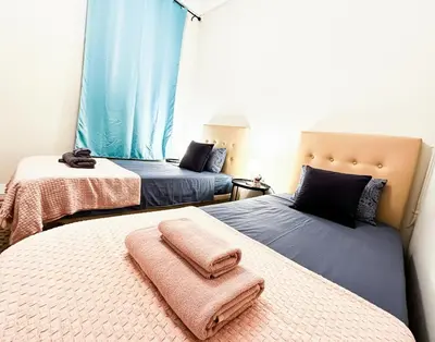 a bedroom with two beds with towels on them at Centric Rooms Ghotic in Barcelona