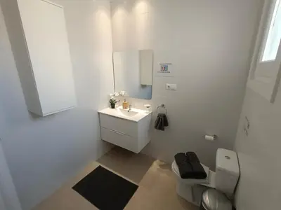 a white bathroom with a toilet and a sink at Centric Rooms Ghotic in Barcelona