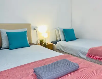 two beds sitting next to each other in a room at Centric Rooms Ghotic in Barcelona