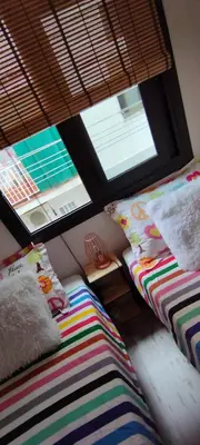 a room with two beds and a window at Apartment Barca 1 Camp Nou in Hospitalet de Llobregat