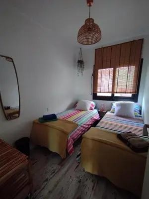 two beds in a room with a mirror at Apartment Barca 1 Camp Nou in Hospitalet de Llobregat