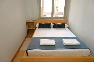 a bedroom with a large bed with two pillows at Homenfun Barcelona Alfonso X in Barcelona