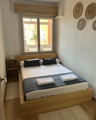a bedroom with a large bed with a window at Homenfun Barcelona Alfonso X in Barcelona