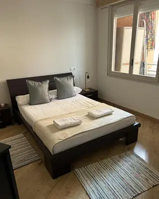 a bedroom with a large bed with two pillows on it at Homenfun Barcelona Alfonso X in Barcelona