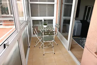 a small balcony with a table and chairs on it at Homenfun Barcelona Alfonso X in Barcelona