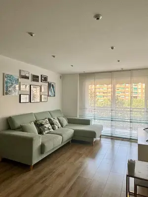 a living room with a couch and a large window at Apartamento Ideal en Poblenou in Barcelona