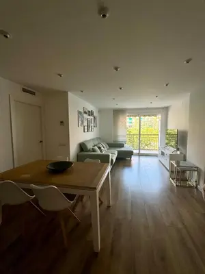 a living room with a table and a couch at Apartamento Ideal en Poblenou in Barcelona