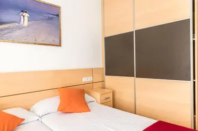 a bedroom with a bed and a painting on the wall at Apartamentos Navas 2 in Barcelona