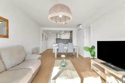 a living room with a couch and a table at Sea View Penthouse in Vilanova i la Geltrú
